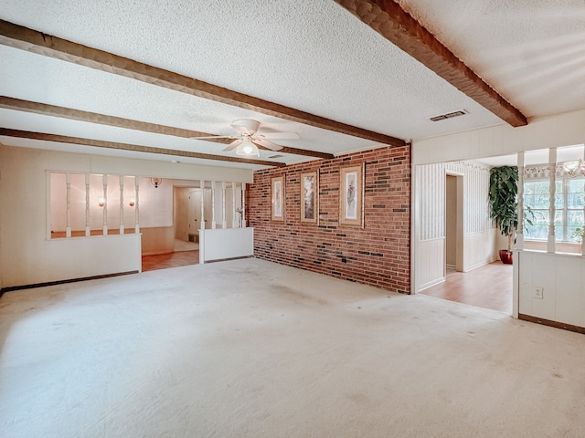 unfurnished living room featuring light carpet, a textured ceiling, beamed ceiling, and ceiling fan