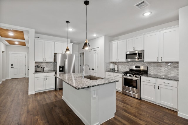 kitchen with white cabinets, dark wood-type flooring, and appliances with stainless steel finishes