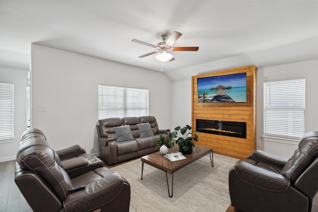 living room with ceiling fan, a fireplace, and light wood-type flooring