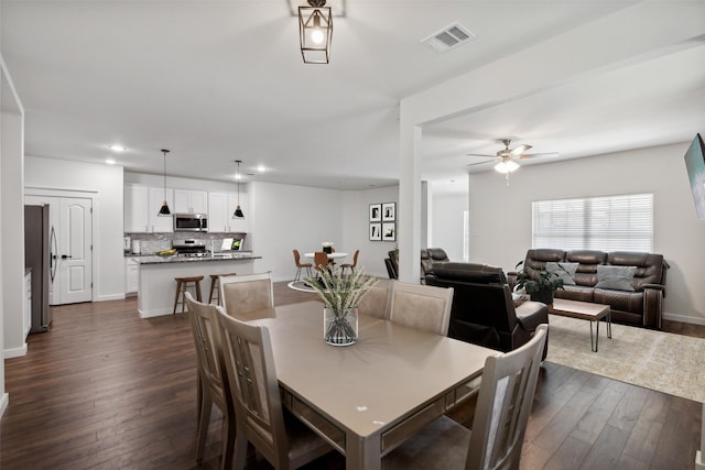 dining area featuring dark hardwood / wood-style floors and ceiling fan