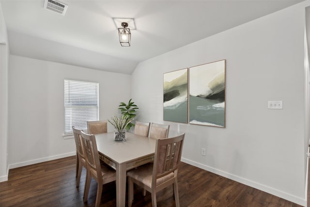 dining area featuring dark hardwood / wood-style floors and lofted ceiling