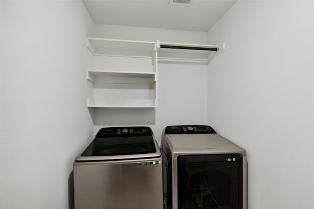 clothes washing area featuring washing machine and dryer