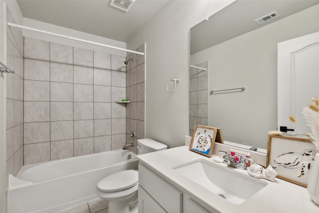 full bathroom featuring tile patterned flooring, tiled shower / bath combo, toilet, and vanity