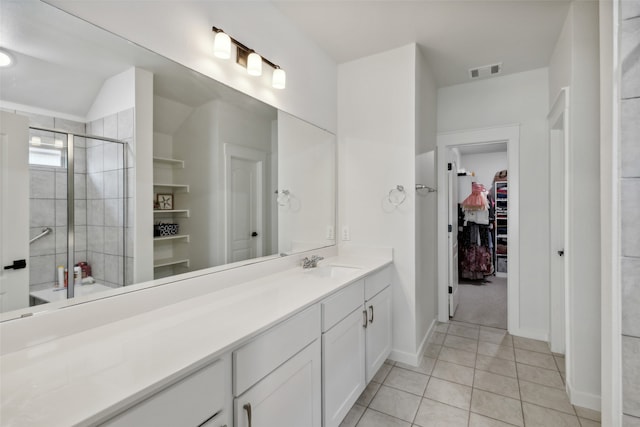 bathroom with vanity, tile patterned floors, and a shower with shower door