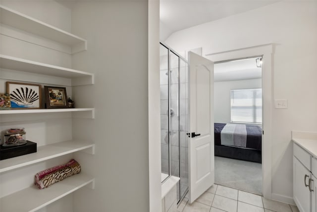 bathroom with vanity, tile patterned floors, and a shower with door