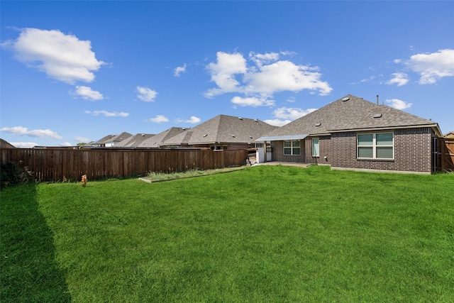 rear view of house featuring a lawn