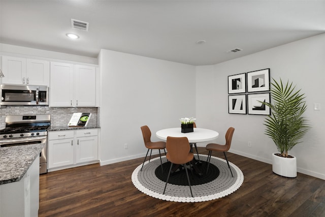 dining space featuring dark wood-type flooring