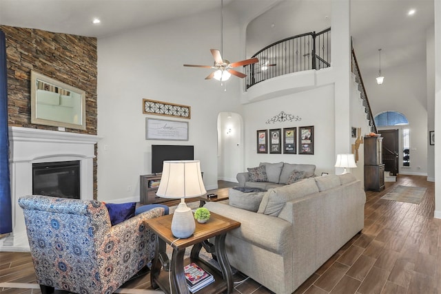 living room with ceiling fan, dark wood-type flooring, and high vaulted ceiling