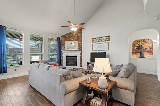 living room with dark hardwood / wood-style floors, a large fireplace, ceiling fan, and high vaulted ceiling