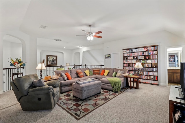 living room featuring light carpet, vaulted ceiling, and ceiling fan