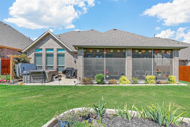 rear view of house with a lawn and a patio