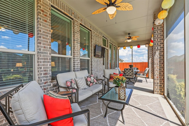 view of patio with an outdoor living space and ceiling fan