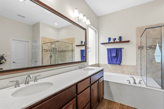 bathroom with wood-type flooring, vanity, and plus walk in shower