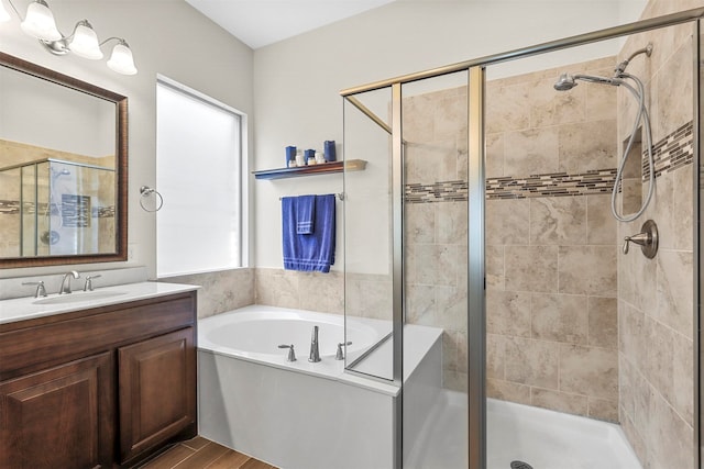 bathroom featuring hardwood / wood-style floors, vanity, and separate shower and tub