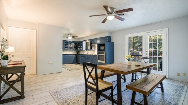 dining room with light wood-type flooring, sink, and ceiling fan