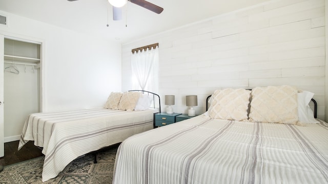 bedroom featuring hardwood / wood-style floors, a closet, multiple windows, and ceiling fan