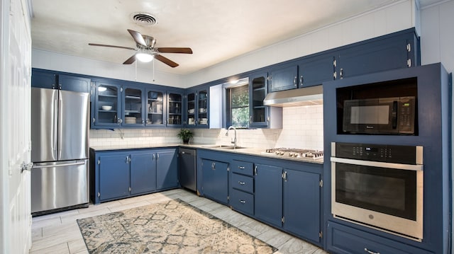 kitchen featuring ceiling fan, stainless steel appliances, and blue cabinetry