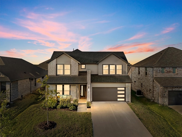 view of front of house featuring a lawn and a garage