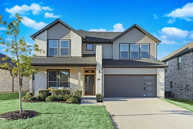 view of front of house with central AC unit, a garage, and a front yard