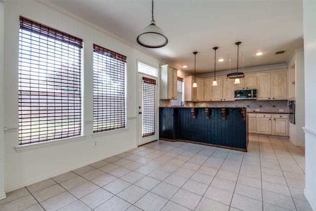 kitchen featuring a healthy amount of sunlight, decorative light fixtures, and light tile patterned floors