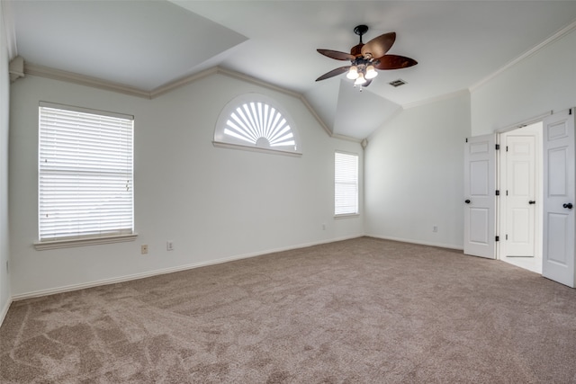 carpeted empty room with crown molding, ceiling fan, and vaulted ceiling