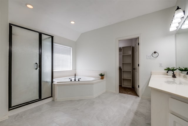 bathroom with independent shower and bath, vanity, and vaulted ceiling