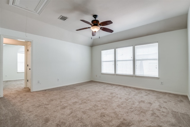 spare room with ceiling fan, plenty of natural light, and light colored carpet