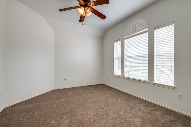 carpeted empty room featuring ceiling fan and vaulted ceiling