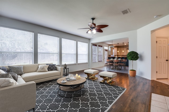 living room featuring hardwood / wood-style flooring and ceiling fan