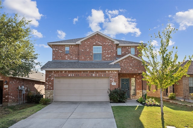 view of front of home with a front yard and a garage