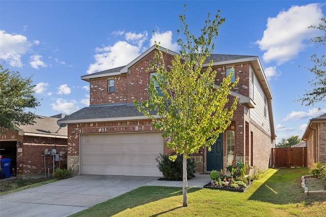 view of front property featuring a front lawn and a garage