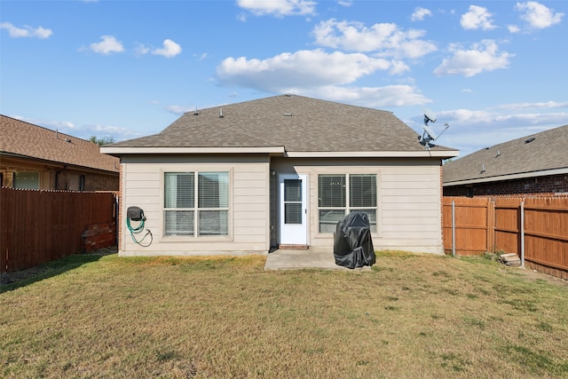 rear view of house featuring a yard