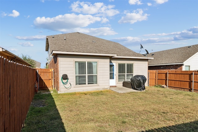 rear view of property featuring a patio and a yard