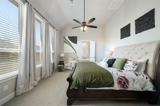 carpeted bedroom with ceiling fan, ensuite bathroom, and lofted ceiling