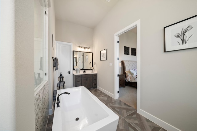 bathroom featuring parquet flooring, vanity, and a bathing tub