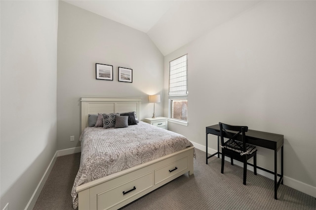 bedroom featuring lofted ceiling and dark carpet