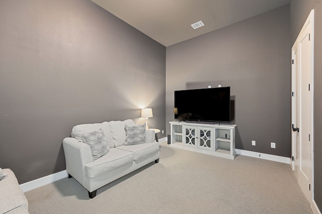 living room featuring light colored carpet and vaulted ceiling