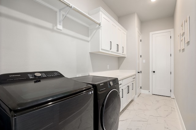 laundry area featuring cabinets and washer and dryer