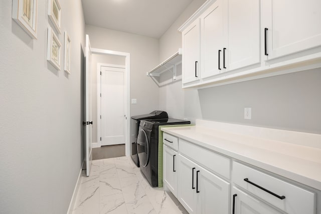 laundry room with cabinets and washing machine and clothes dryer