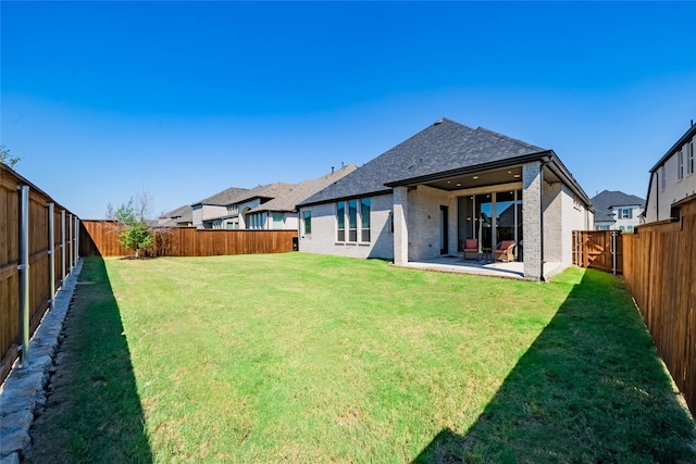 back of property with a patio and a lawn