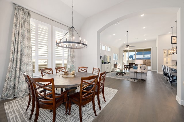 dining room featuring lofted ceiling, dark hardwood / wood-style floors, and ceiling fan with notable chandelier