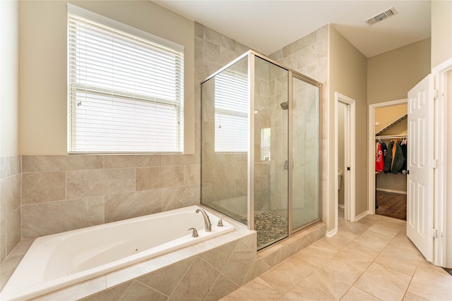 bathroom featuring shower with separate bathtub and tile patterned floors