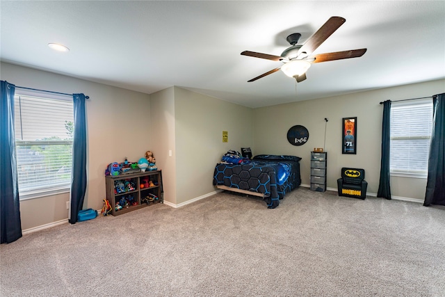 bedroom with light carpet and ceiling fan