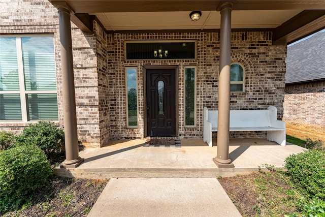 view of exterior entry with a porch