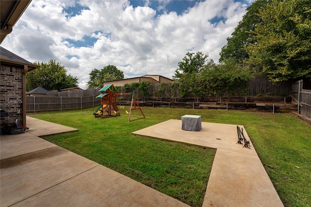 view of yard with a patio and a playground