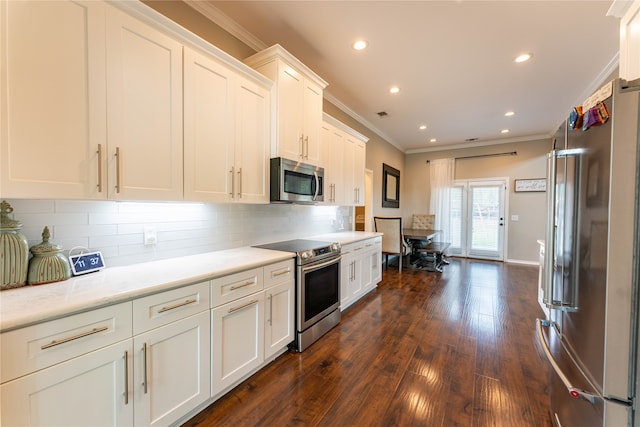 kitchen featuring white cabinets, stainless steel appliances, crown molding, and dark hardwood / wood-style flooring