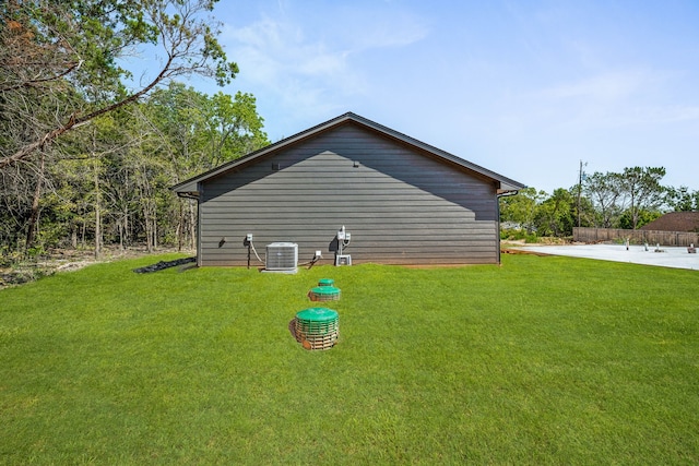 view of property exterior featuring a yard and central AC unit