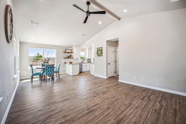 unfurnished living room with lofted ceiling with beams, dark hardwood / wood-style floors, ceiling fan, and sink