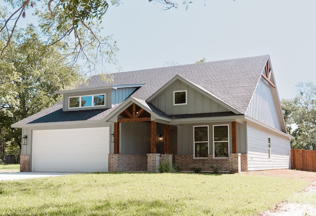 craftsman-style home featuring a front yard and a garage