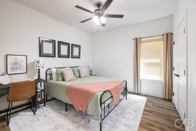 bedroom with wood-type flooring and ceiling fan